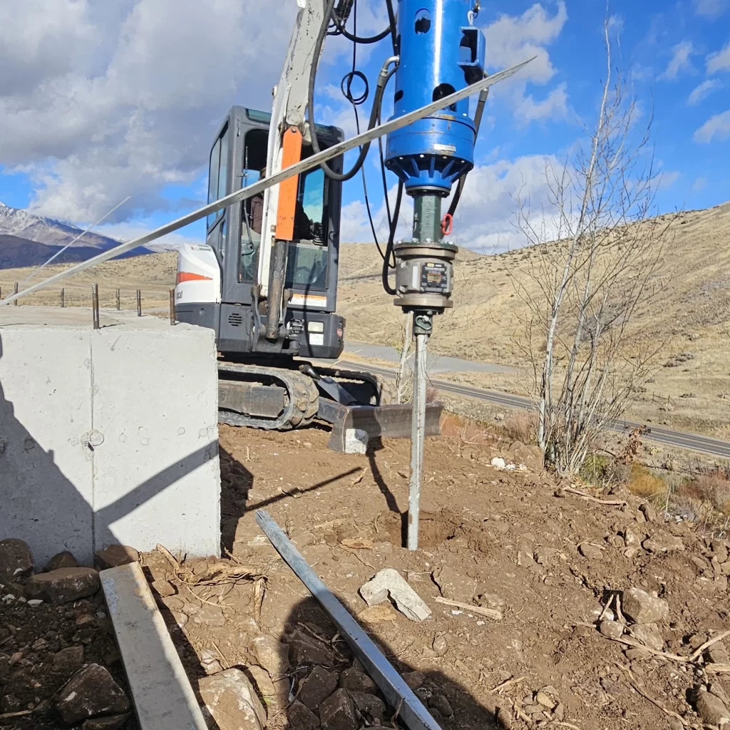 Crew from Utah Screw Pile advancing a helical pier into Utah soils on residential foundation