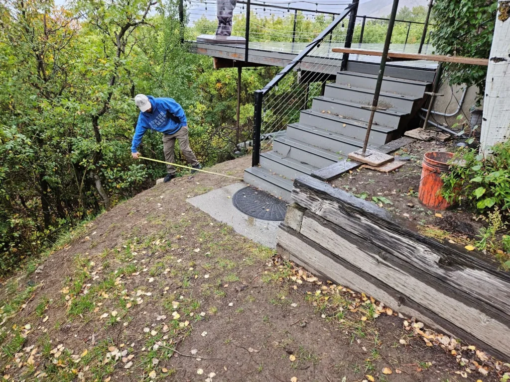 Contractor conducting layout before placing footings on slopes