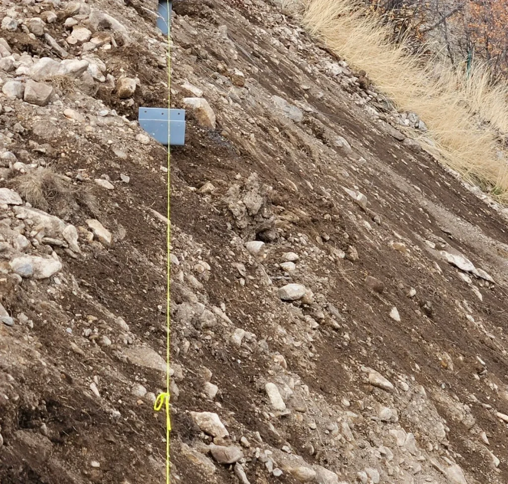 placing footings on slopes using helical piers